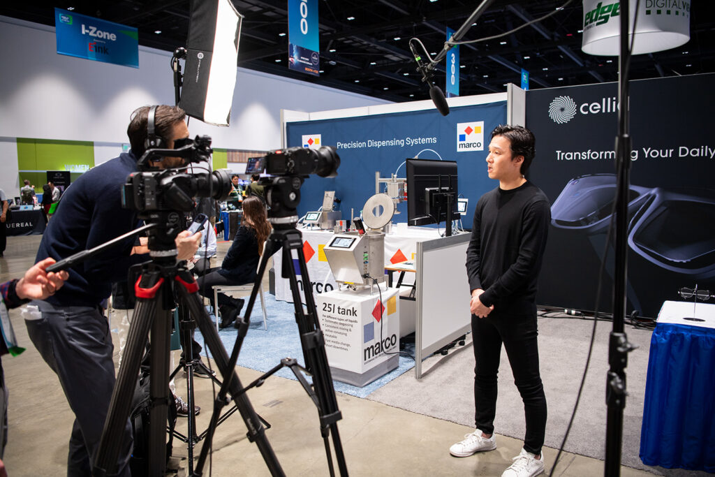 Camera man filming an exhibitor.